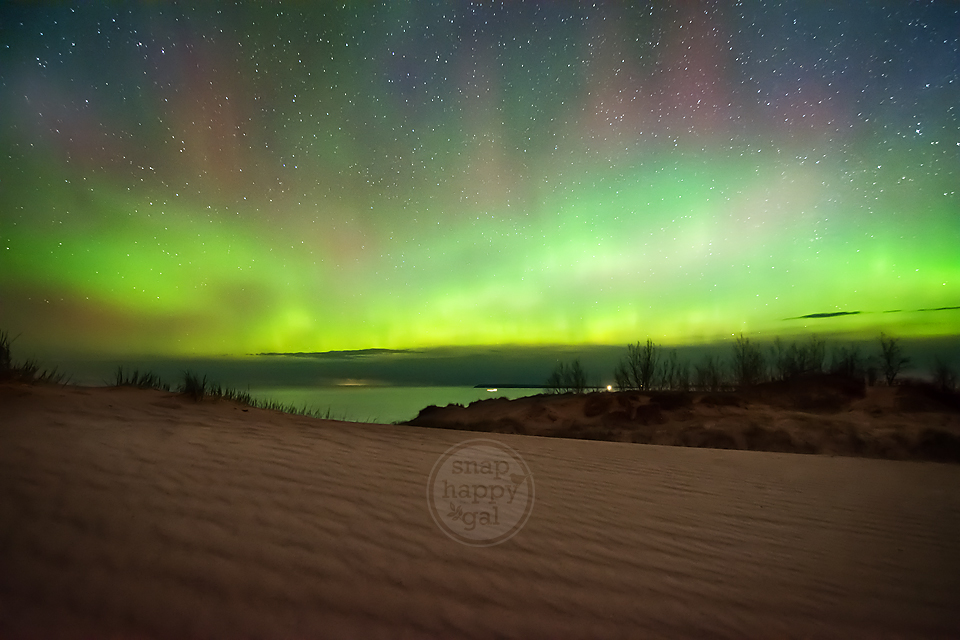 Photo: Northern Lights glow vividly over the shifting sands of Michigan's Sleeping Bear Dunes