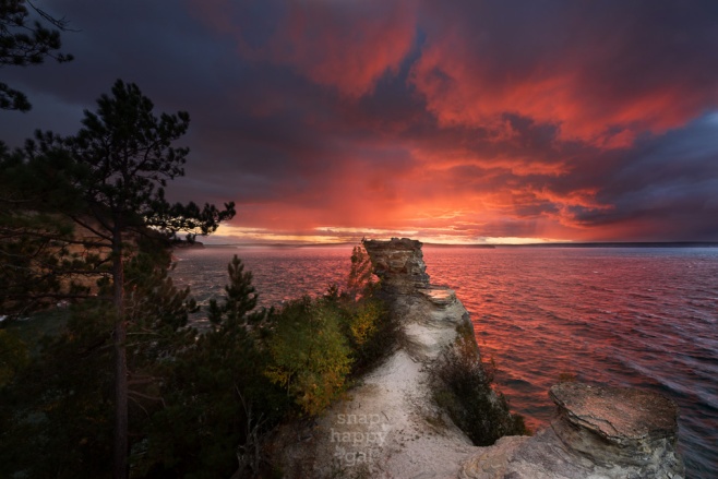 A dramatic sunset unfolds above Lake Superior at Miners Castle, Pictured Rocks