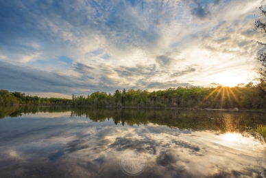 A golden sunset reflects in Fern Lake at the Timbers Recreation Area outside Traverse City