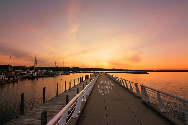 Photo: A vibrant orange sunset shines above the pier in Traverse City's Clinch Marina