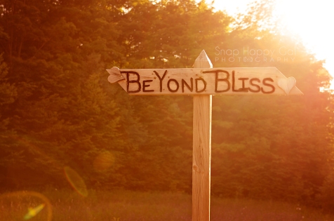 Photo: Follow your bliss, beyond bliss road sign, bokeh, lens flare