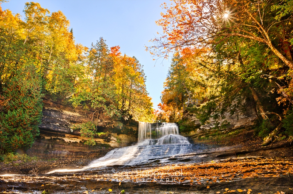 Photo: fall color and a sunburst at Laughing Whitefish Falls waterfall