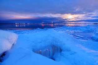 Photo: ice formations and Mackinac Bridge + reflections during moonrise