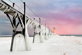 Photo: Pink sunrise, pier ice formations, Manistee Lighthouse