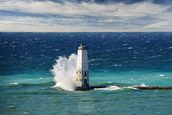 An autumn gale creates big waves with big swan-like splashes at the Frankfort Lighthouse in Lake Michigan