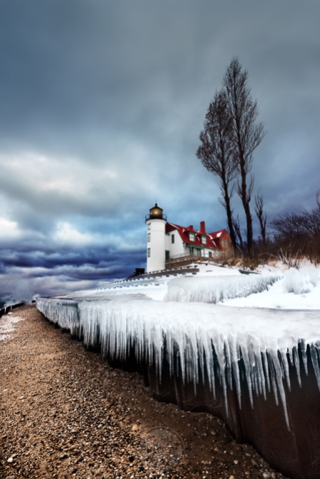 Pointy icicles hang below Point Betsie Lighthouse under moody skies