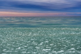 Moody sky, mercurial water, and frozen ice pancakes on Lake Michigan in the winter
